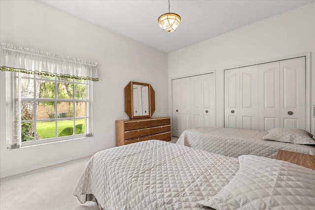 4026 S Lake Orlando Pkwy, Orlando, FL 32808 - bedroom with multiple closets, carpet flooring, and baseboards