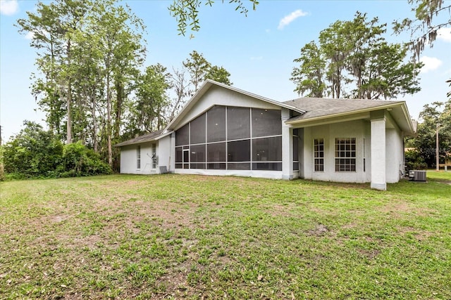 4026 S Lake Orlando Pkwy, Orlando, FL 32808 - rear view of property with a sunroom, a lawn, central AC unit, and stucco siding