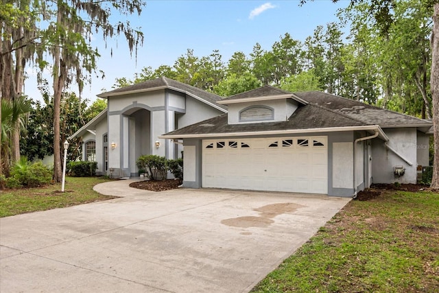4026 S Lake Orlando Pkwy, Orlando, FL 32808 - view of front of property with an attached garage, stucco siding, driveway, a shingled roof, and a front lawn