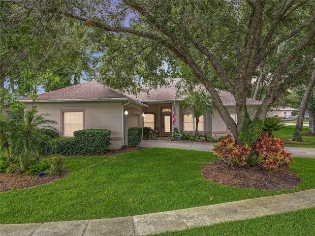 1701 Lucky Pennie Way, Apopka, FL 32712 - view of front of home with stucco siding, a garage, a front lawn, driveway, and roof with shingles