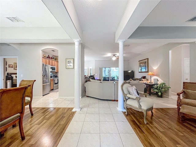 1701 Lucky Pennie Way, Apopka, FL 32712 - living area with decorative columns, light wood-style floors, and a ceiling fan