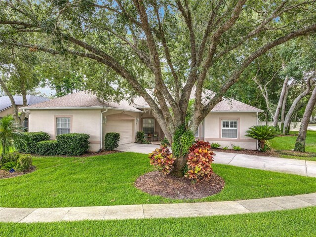 1701 Lucky Pennie Way, Apopka, FL 32712 - view of front of property featuring stucco siding, driveway, a front yard, and an attached garage