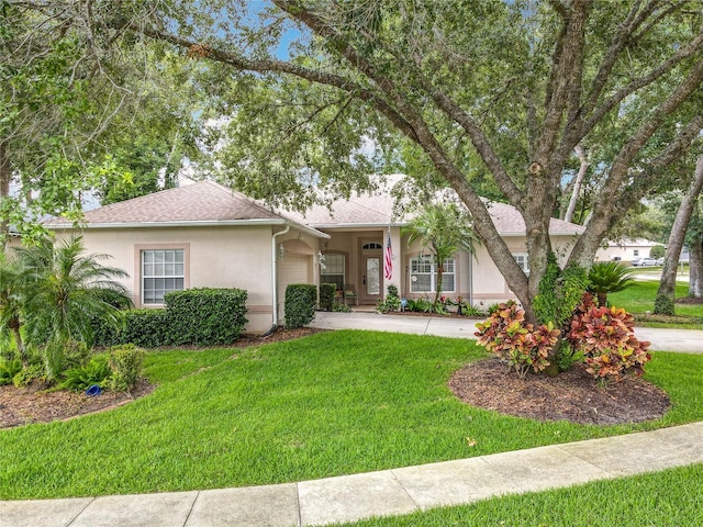 1701 Lucky Pennie Way, Apopka, FL 32712 - view of front facade with stucco siding, an attached garage, a front yard, concrete driveway, and a shingled roof