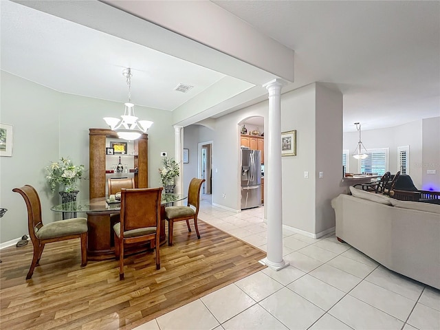 1701 Lucky Pennie Way, Apopka, FL 32712 - dining room featuring light tile patterned floors, ornate columns, a chandelier, and baseboards
