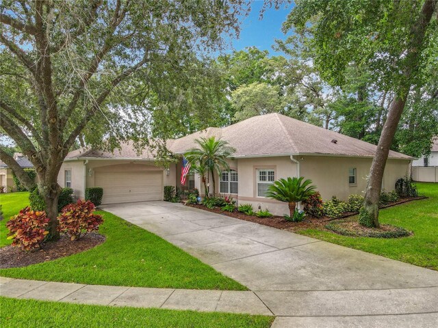 1701 Lucky Pennie Way, Apopka, FL 32712 - single story home with stucco siding, a garage, a front lawn, and driveway