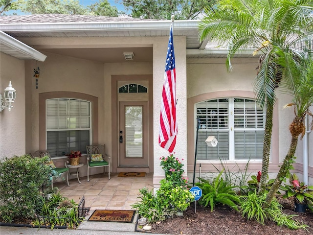 1701 Lucky Pennie Way, Apopka, FL 32712 - view of exterior entry featuring stucco siding and covered porch