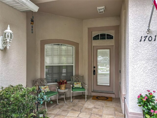 1701 Lucky Pennie Way, Apopka, FL 32712 - view of exterior entry featuring stucco siding and covered porch