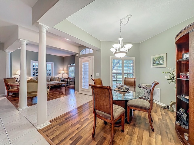 1701 Lucky Pennie Way, Apopka, FL 32712 - dining space with decorative columns, healthy amount of natural light, a chandelier, and baseboards