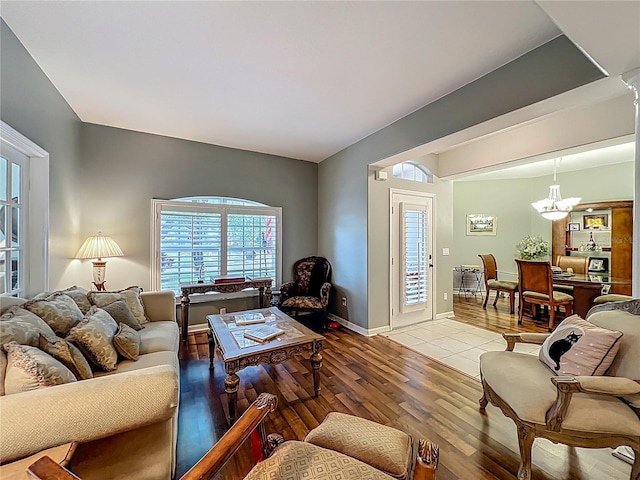 1701 Lucky Pennie Way, Apopka, FL 32712 - living room with light wood-style floors, a chandelier, and baseboards