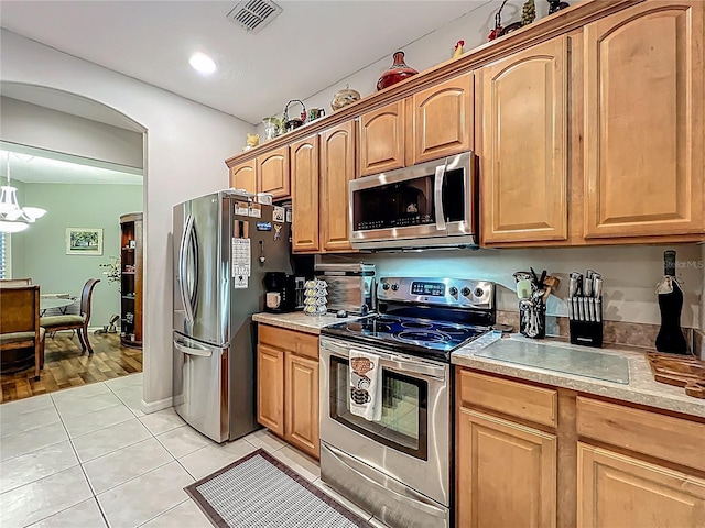 1701 Lucky Pennie Way, Apopka, FL 32712 - kitchen featuring appliances with stainless steel finishes, light countertops, light tile patterned flooring, and a chandelier