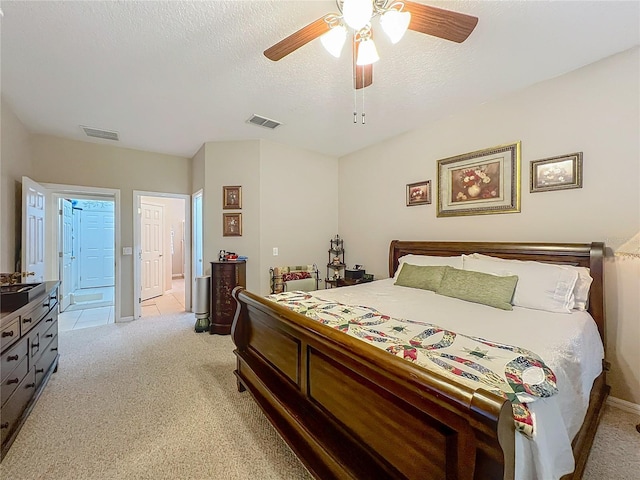1701 Lucky Pennie Way, Apopka, FL 32712 - bedroom featuring light carpet, a ceiling fan, a textured ceiling, connected bathroom, and baseboards