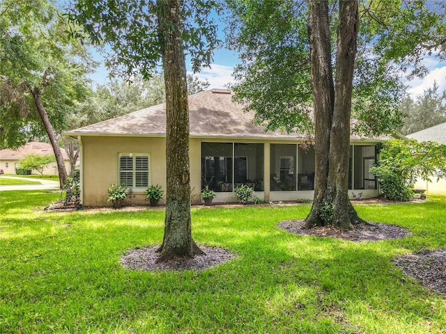 1701 Lucky Pennie Way, Apopka, FL 32712 - rear view of property with a sunroom, a yard, and stucco siding