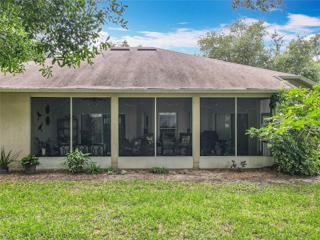 1701 Lucky Pennie Way, Apopka, FL 32712 - rear view of property featuring a yard, a sunroom, a shingled roof, and stucco siding
