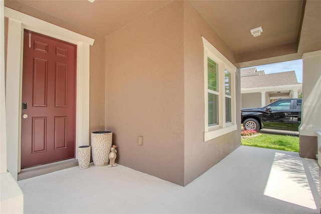 13940 Magnolia Ridge Loop, Winter Garden, FL 34787 - doorway to property featuring stucco siding and a porch