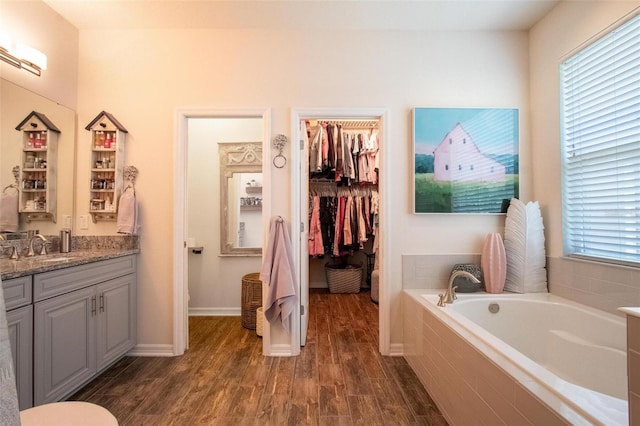 13940 Magnolia Ridge Loop, Winter Garden, FL 34787 - full bath with a garden tub, wood finished floors, vanity, and a spacious closet