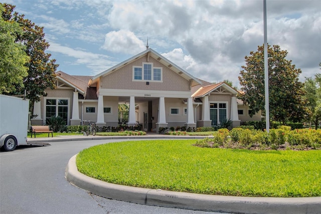 13940 Magnolia Ridge Loop, Winter Garden, FL 34787 - craftsman inspired home featuring a front lawn, a porch, and stucco siding