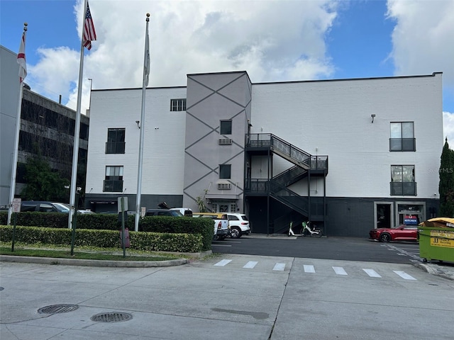 62 W Colonial Dr Unit 302, Orlando, FL 32801 - view of building exterior featuring uncovered parking and stairs