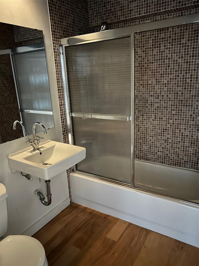 62 W Colonial Dr Unit 302, Orlando, FL 32801 - bathroom featuring wood finished floors and enclosed tub / shower combo