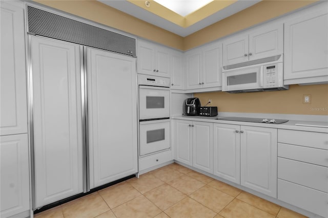 3010 Grand Bay Blvd Unit 472, Longboat Key, FL 34228 - kitchen with white appliances, white cabinetry, light countertops, and light tile patterned floors