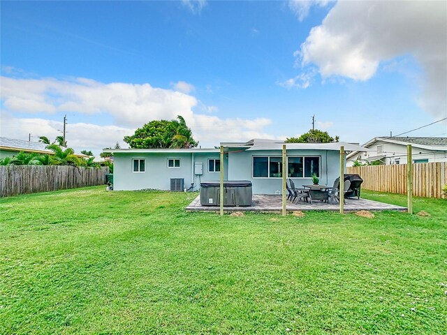931 S Orlando Ave, Cocoa Beach, FL 32931 - back of property with a hot tub, a patio, central AC, and stucco siding