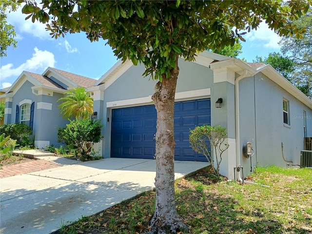 2474 Cimmaron Ash Way, Apopka, FL 32703 - view of front facade with stucco siding, an attached garage, and driveway