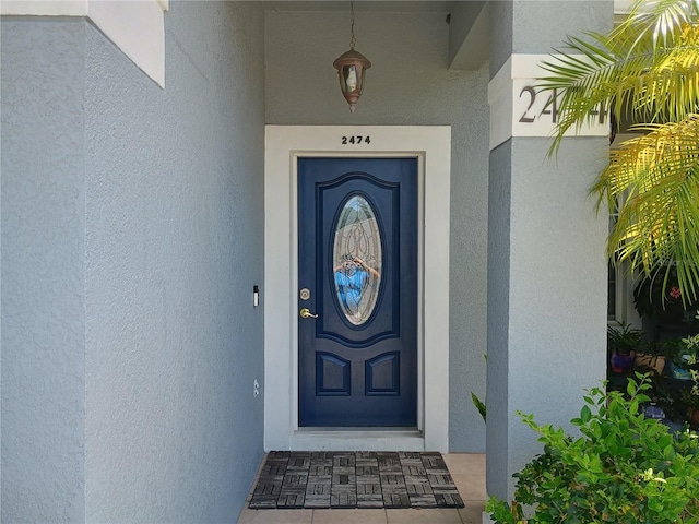 2474 Cimmaron Ash Way, Apopka, FL 32703 - view of exterior entry featuring stucco siding