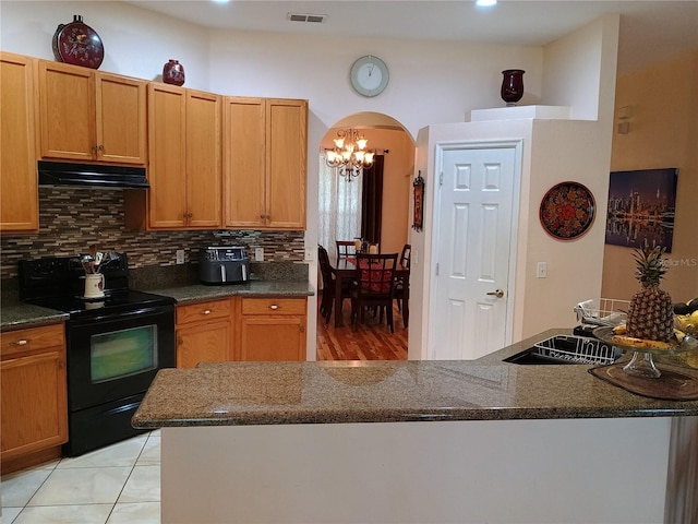 2474 Cimmaron Ash Way, Apopka, FL 32703 - kitchen with electric range, ventilation hood, arched walkways, a sink, and backsplash