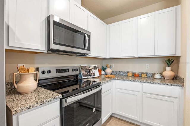 5625 Brosnan Rd, Saint Cloud, FL 34771 - kitchen with appliances with stainless steel finishes and white cabinetry