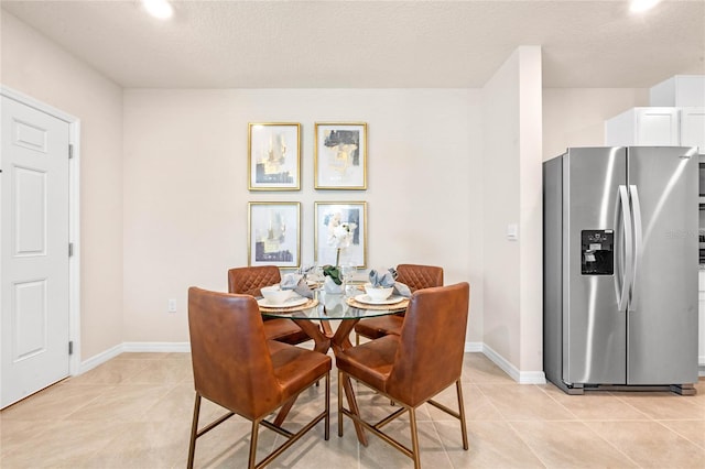 5625 Brosnan Rd, Saint Cloud, FL 34771 - dining space with light tile patterned flooring, baseboards, and a textured ceiling
