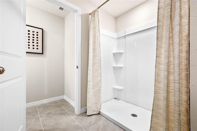 5625 Brosnan Rd, Saint Cloud, FL 34771 - bathroom with tile patterned flooring, a shower with curtain, and baseboards