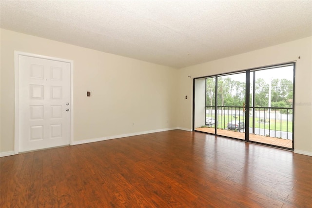 1221 S Pine Ridge Cir Unit A2, Sanford, FL 32773 - empty room with wood finished floors, baseboards, and a textured ceiling