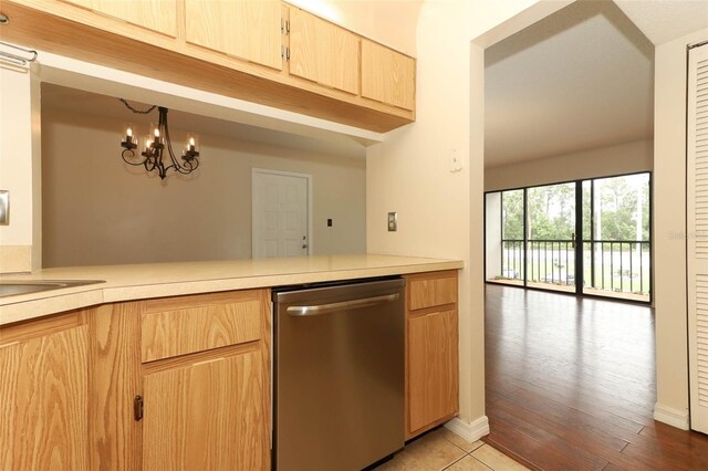 1221 S Pine Ridge Cir Unit A2, Sanford, FL 32773 - kitchen with dishwasher, light brown cabinetry, light countertops, and a peninsula