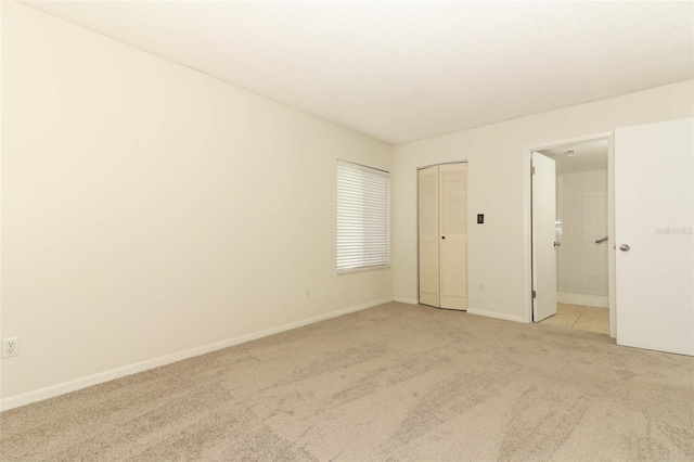 1221 S Pine Ridge Cir Unit A2, Sanford, FL 32773 - unfurnished bedroom featuring light carpet, baseboards, and a closet