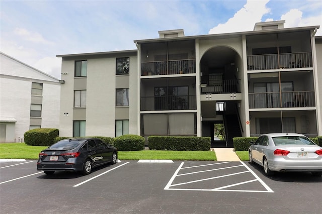 1221 S Pine Ridge Cir Unit A2, Sanford, FL 32773 - view of building exterior featuring uncovered parking