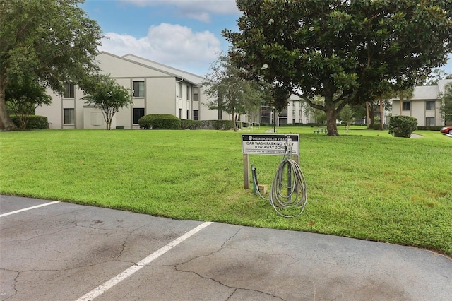1221 S Pine Ridge Cir Unit A2, Sanford, FL 32773 - surrounding community with a lawn and uncovered parking