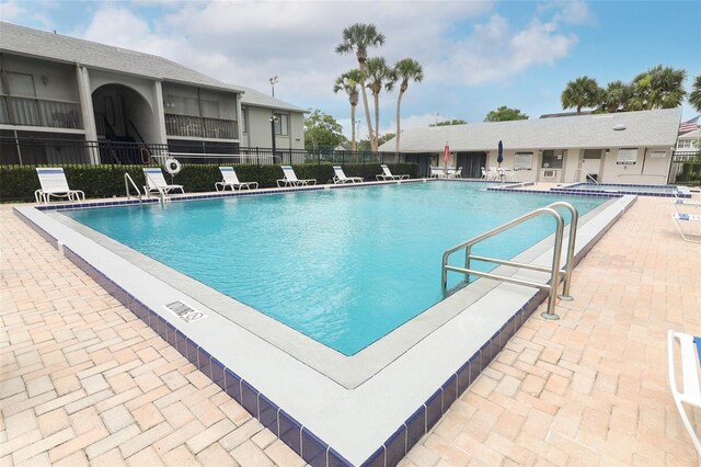 1221 S Pine Ridge Cir Unit A2, Sanford, FL 32773 - community pool featuring a patio area