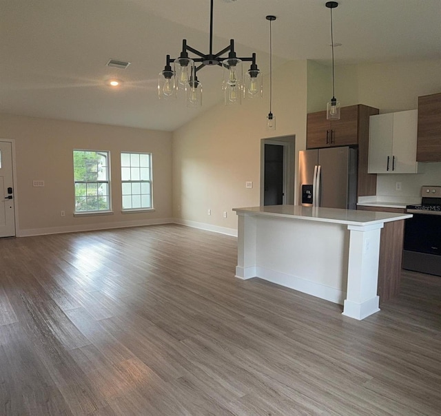 524 Marion Oaks Blvd, Ocala, FL 34473 - kitchen featuring appliances with stainless steel finishes, light countertops, light wood finished floors, open floor plan, and a high ceiling
