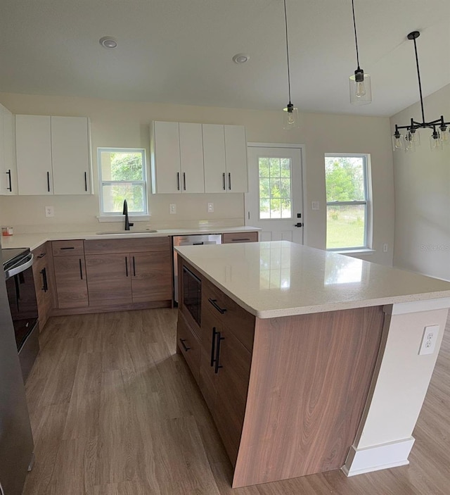 524 Marion Oaks Blvd, Ocala, FL 34473 - kitchen with a sink, light wood finished floors, a kitchen island, built in microwave, and electric stove