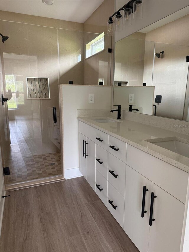 524 Marion Oaks Blvd, Ocala, FL 34473 - bathroom with a stall shower, double vanity, and wood finished floors