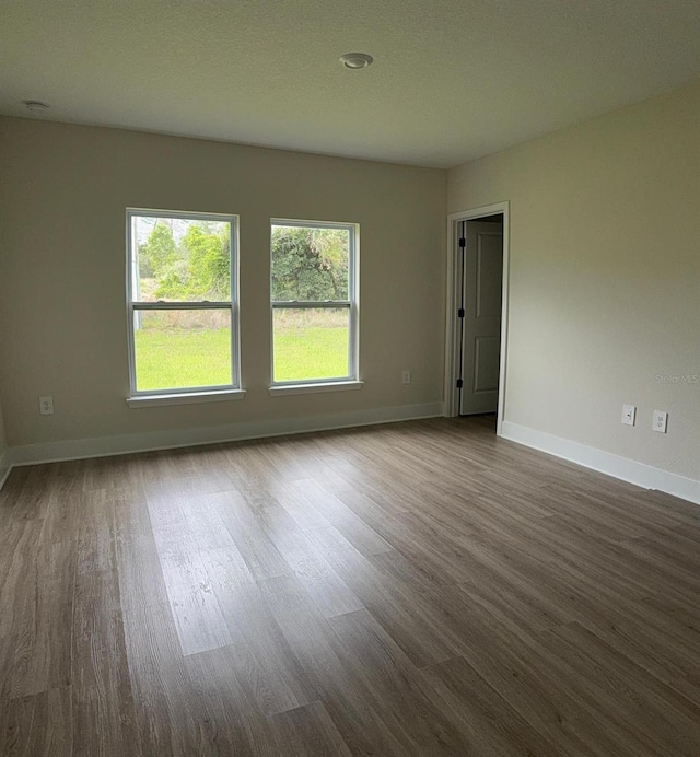 524 Marion Oaks Blvd, Ocala, FL 34473 - empty room with dark wood-style flooring and baseboards