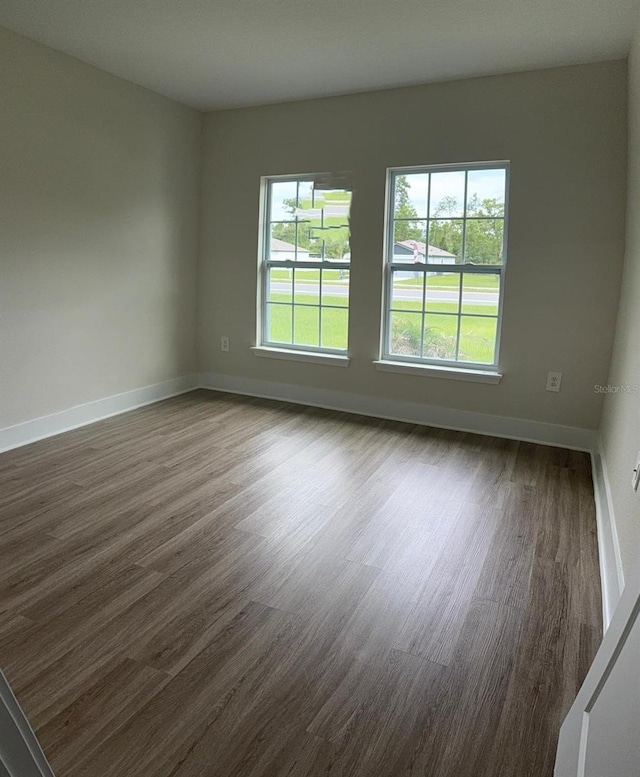 524 Marion Oaks Blvd, Ocala, FL 34473 - unfurnished room with healthy amount of natural light, dark wood-style flooring, and baseboards