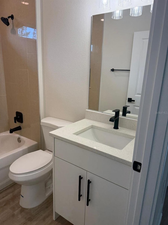 524 Marion Oaks Blvd, Ocala, FL 34473 - full bathroom with vanity, wood finished floors, toilet, bathing tub / shower combination, and a textured wall