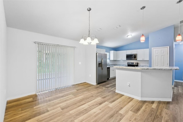 395 Alcazar Ave, De Leon Springs, FL 32130 - kitchen with appliances with stainless steel finishes, light wood-style floors, white cabinets, a chandelier, and vaulted ceiling