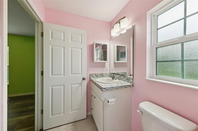 395 Alcazar Ave, De Leon Springs, FL 32130 - half bath featuring vanity, plenty of natural light, toilet, and baseboards