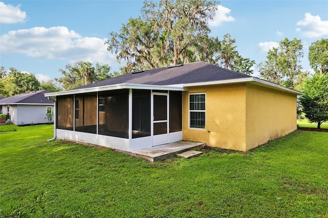 395 Alcazar Ave, De Leon Springs, FL 32130 - rear view of house featuring a sunroom, a lawn, and stucco siding
