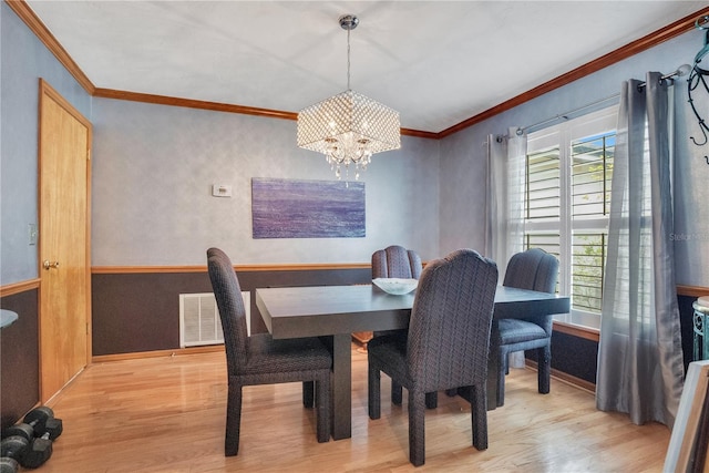 616 Magnolia St, Windermere, FL 34786 - dining space featuring wood finished floors, ornamental molding, and a chandelier