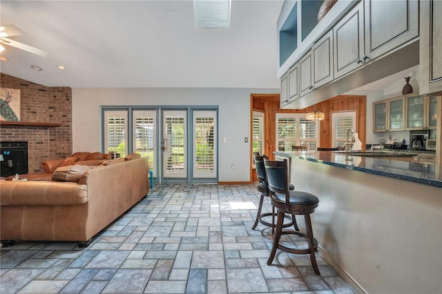 616 Magnolia St, Windermere, FL 34786 - living room featuring a ceiling fan, recessed lighting, a fireplace, and light stone finish floors