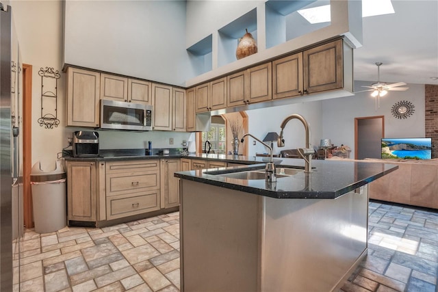 616 Magnolia St, Windermere, FL 34786 - kitchen featuring stainless steel microwave, a high ceiling, ceiling fan, open floor plan, and dark stone countertops