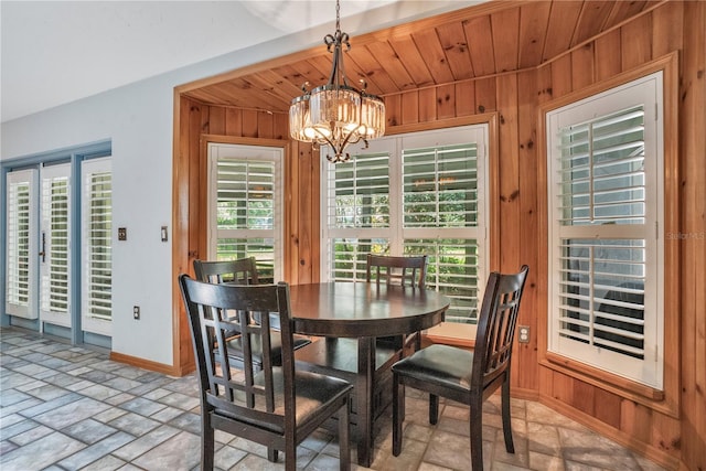 616 Magnolia St, Windermere, FL 34786 - dining area featuring wood walls, a chandelier, light stone finish flooring, and wood ceiling
