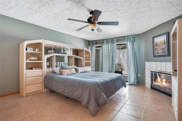 616 Magnolia St, Windermere, FL 34786 - bedroom with a fireplace, tile patterned flooring, access to exterior, a textured ceiling, and ceiling fan